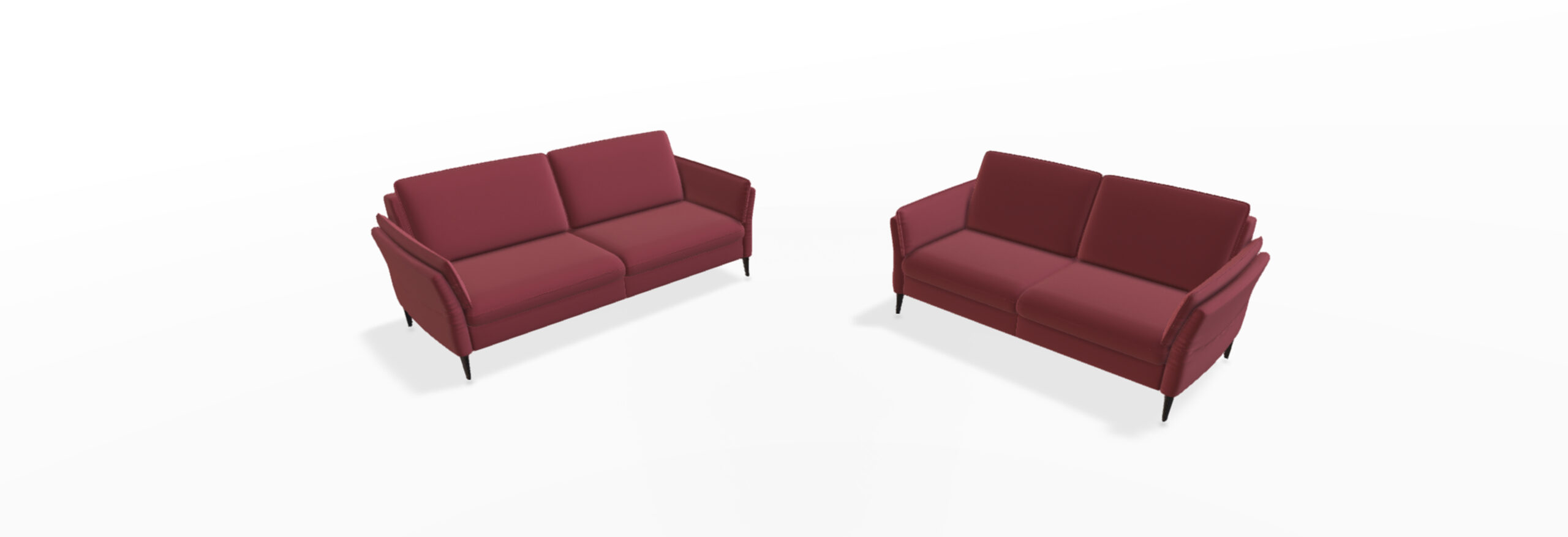 Zwei rote Sofas mit dunklen Beinen