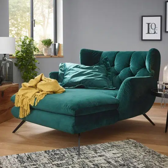 Gemütlich eingerichtetes, grünes Wohnzimmer.