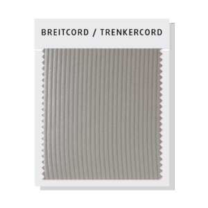 Nahaufnahme eines Sofas mit Breitcord-Bezug, der für seine weiche, aber robuste Struktur bekannt ist. Der grobe, gleichmäßige Cordstruktur sorgt für ein angenehmes Sitzgefühl und eine markante Optik.